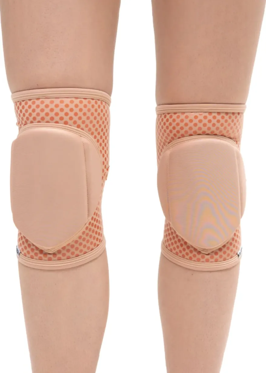 IMG_5908 Person wearing peach knee pads with dotted pattern on both knees, shown from the back/behind view