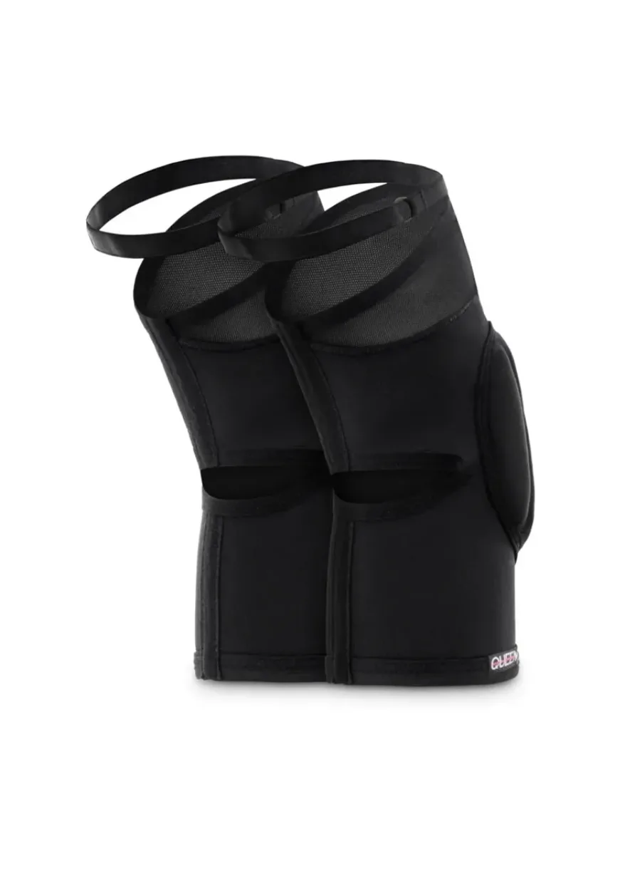 IMG_4957 Pair of black adjustable shin guards with velcro straps standing upright, athletic protective gear for the legs.