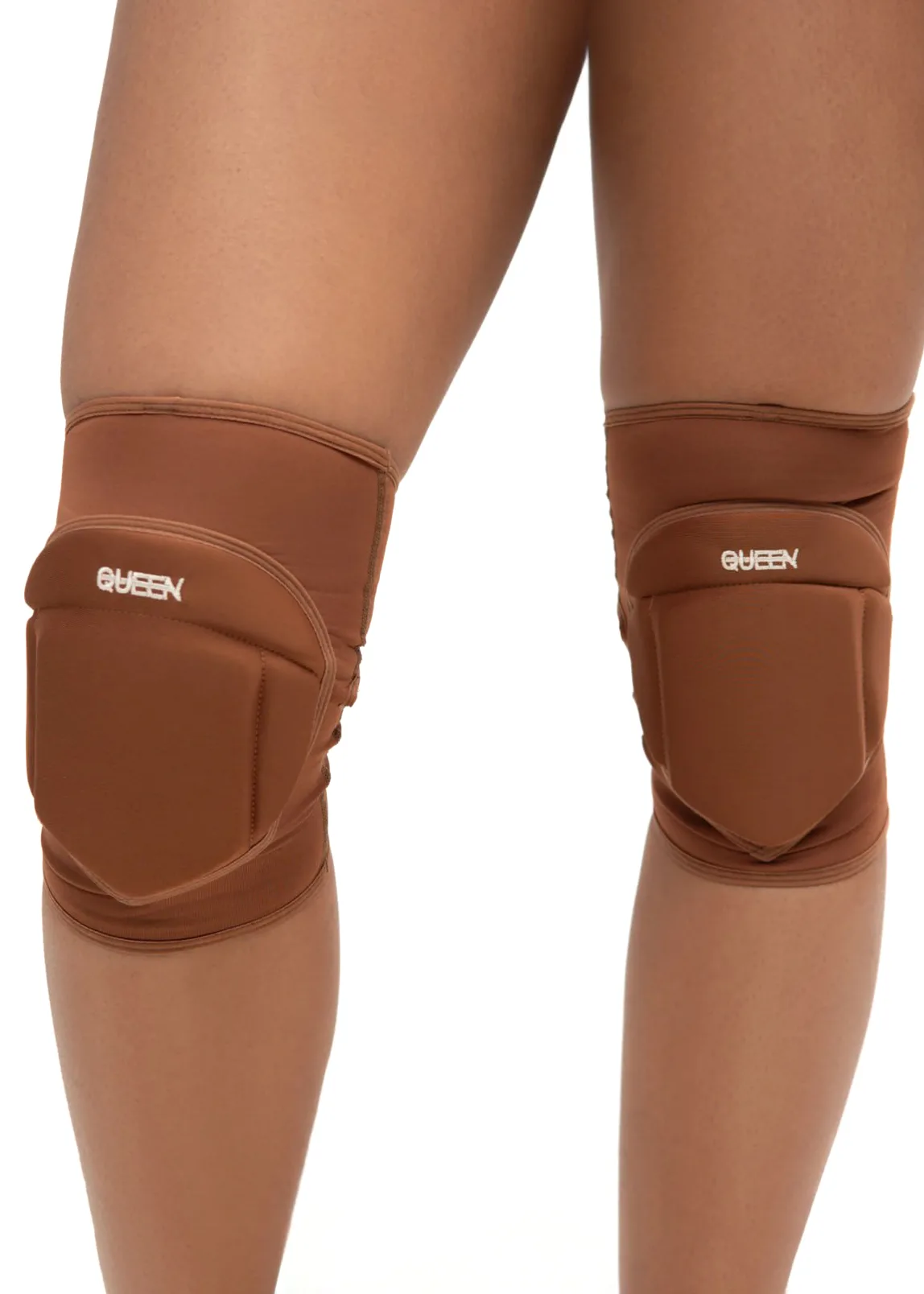 IMG_5939 Brown knee pads worn on the knees of two legs, with a white 'QUEEN' logo on each pad for a protective sports accessory