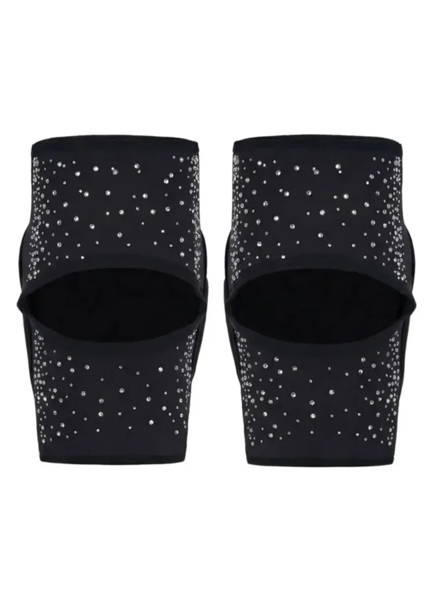 IMG_4966 Pair of black slip-on sandals with rhinestone embellishments behind open toes or straps, sparkling detail visible across the footwear coasted in crystals