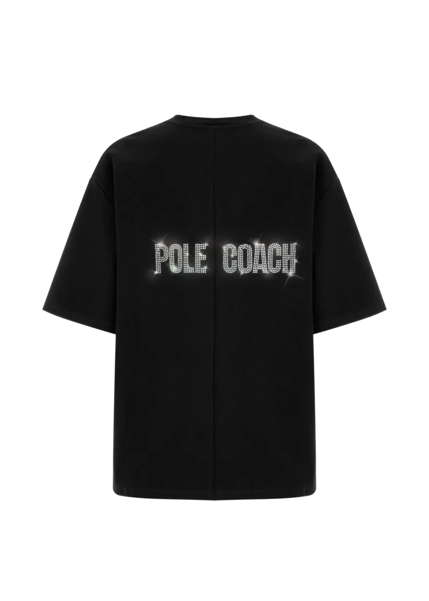 6 Back view of a black oversized T-shirt with 'POLE COACH' in sparkling rhinestones across the lower back.