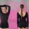 Two women in black athletic outfits pose in a studio with a pink paint-splatter backdrop and a Queen logo in the corner.