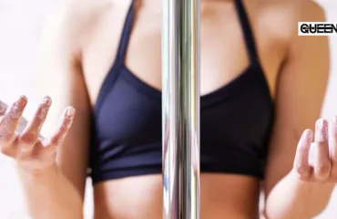 Sweaty Hands on the Pole Grip Aids That Actually Work Pole dancer in a black sports bra with chalky hands gripping a vertical chrome pole.